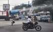 Municipal corporation workers use a mist cannon to sanitize