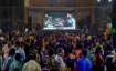 Cricket fans watch the World Cup T20 match of India and