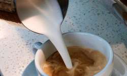  A barista pours steamed milk in a coffee at a cafe in Los