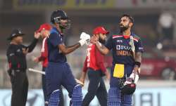 Hardik Pandya of India embraces Virat Kohli as they leave