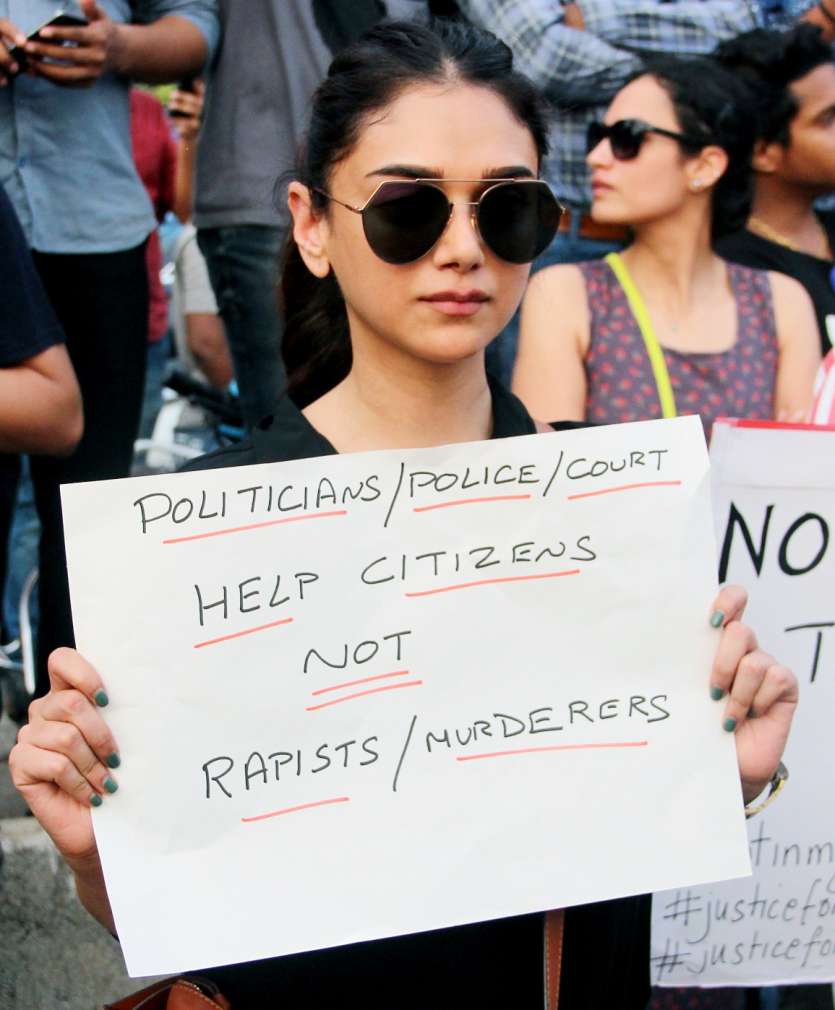   Actress Aditi Rao Hydari holding placard at the rally.